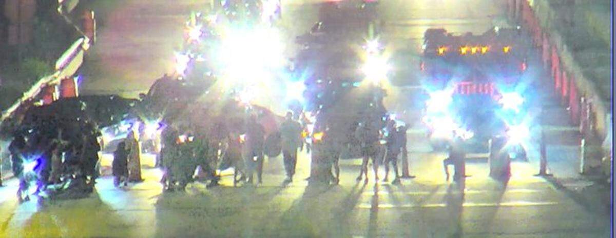 Five people were arrested after a group of protesters blocked Interstate 277 late Wednesday, CMPD says