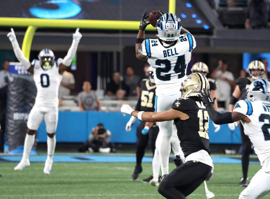 Carolina Panthers safety Vonn Bell, back to camera, intercepts a pass by New Orleans Saints quarterback Derek Carr during second-quarter action at Bank of America Stadium on Monday, September 18, 2023.