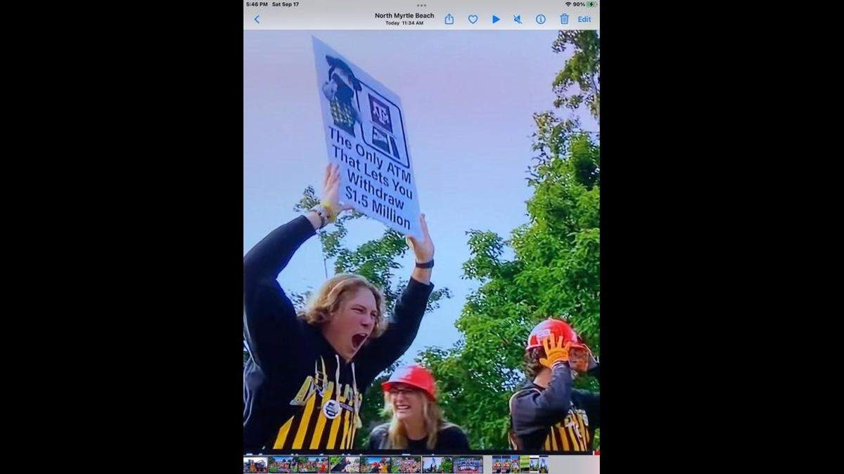 Appalachian State University freshman Zackary Carr of Gastonia shouts to the crowd while hold the poster that earned him a year of free tuition during the ESPN College GameDay broadcast in Sept. 17, 2022.