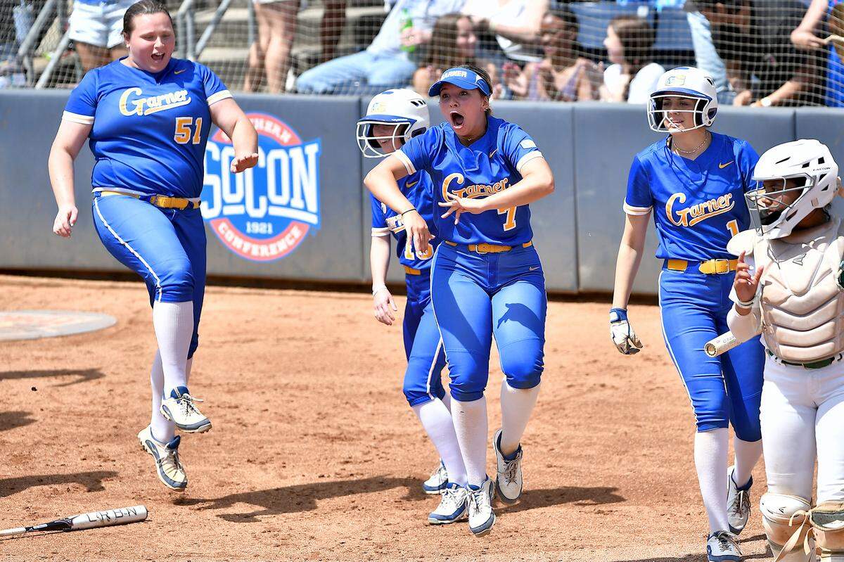 Garner’s Leigh Anna Carter (7) and teammates rush home plate to congratulate Ella Siemiaczko (9) after her three-run home in the second inning. The Garner Trojans and the Weddington Warriors met in the NCHSAA 4A Softball Championship Series in Greensboro, N.C. on June 1, 2024.