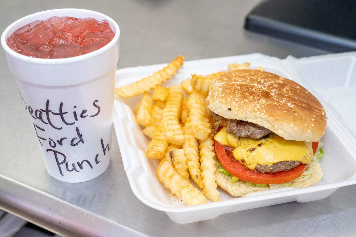 A Fat Boy Burger has two patties with lettuce, tomato, ketchup, mustard, coleslaw and chili.