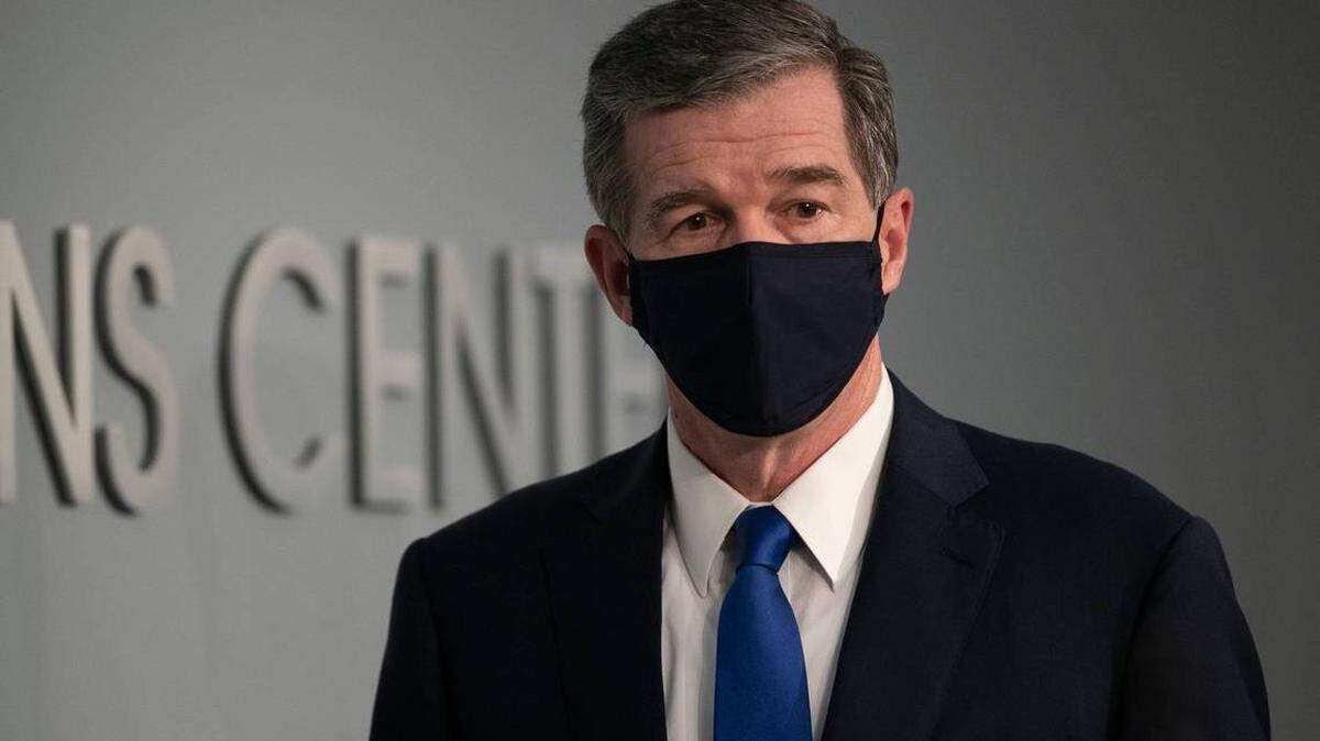North Carolina Gov. Roy Cooper arrives for a press briefing on the COVID-19 virus at the Emergency Operations Center on Wednesday. He announced that the state will remain in Phase Two for another three weeks and made face coverings mandatory in public.