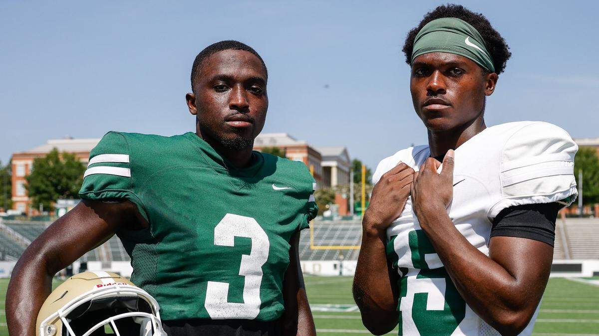 UNC Charlotte wide receiver Jairus Mack, left, and his twin brother, defensive back Jaavan Mack, pose for a portrait after practice in Charlotte on Wednesday, August 28, 2024.