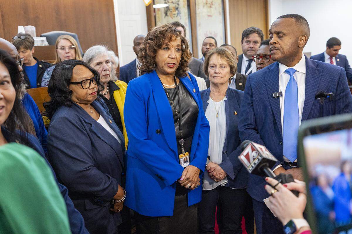 Rep. Carolyn Logan, a Mecklenburg County Democrat, center, condemns recent federal law enforcement operations in Charlotte during a news conference with fellow House and Senate Democrats on the House floor on Nov. 17, 2025, at the North Carolina Legislative Building in Raleigh.