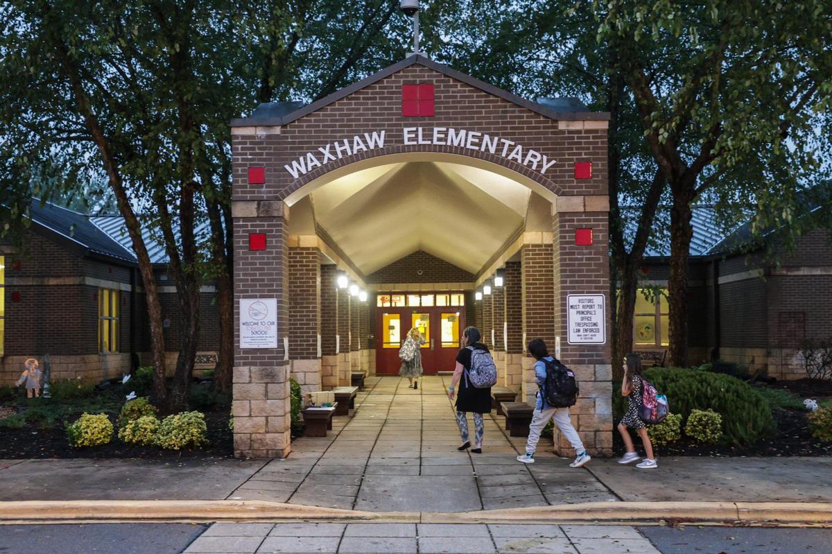 Teachers and children arrive for the first day of school at Waxhaw Elementary School on Monday, August 28, 2023.