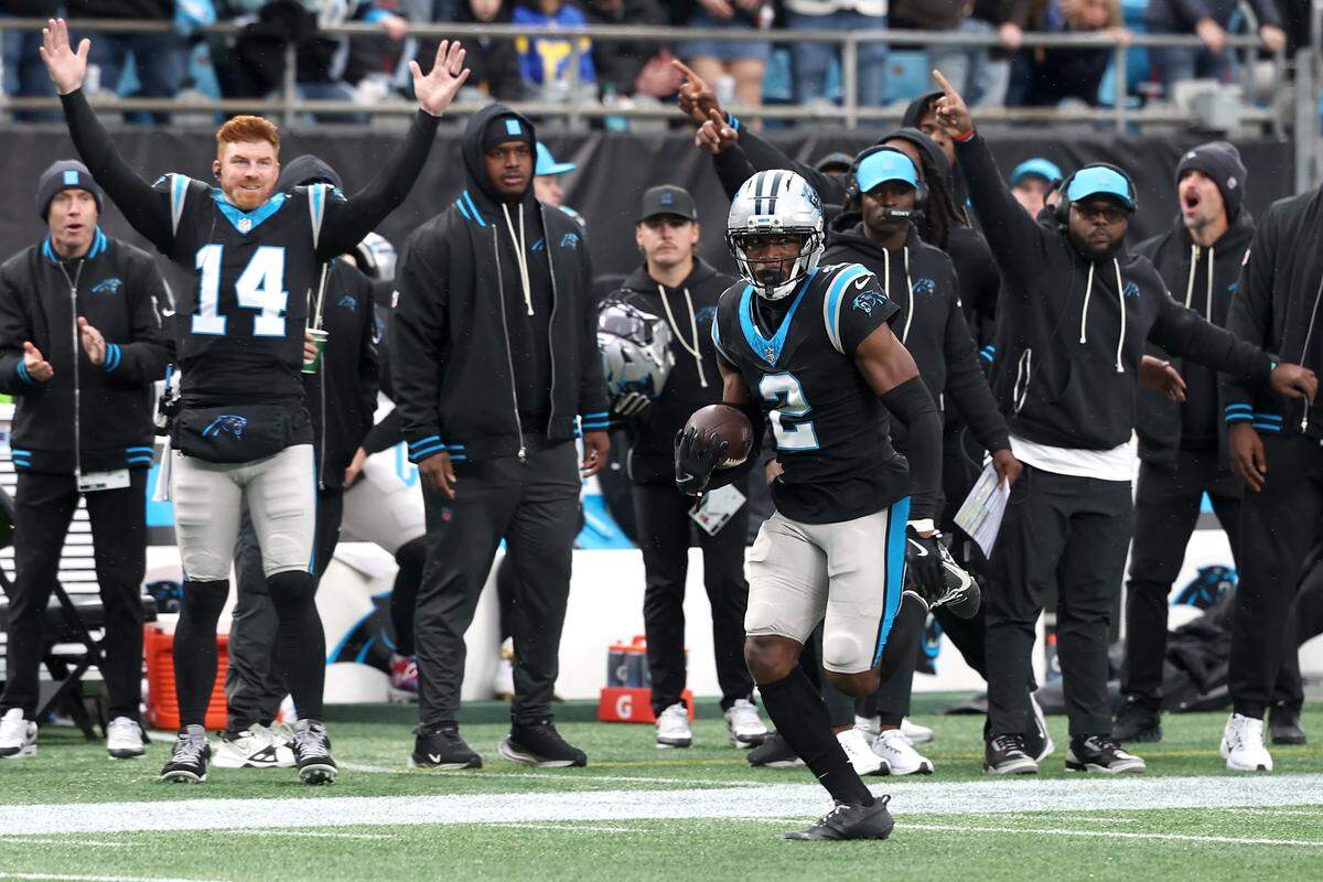Carolina Panthers cornerback Mike Jackson runs to the end zone after intercepting a pass meant for Los Angeles Rams wide receiver Puka Nacua.