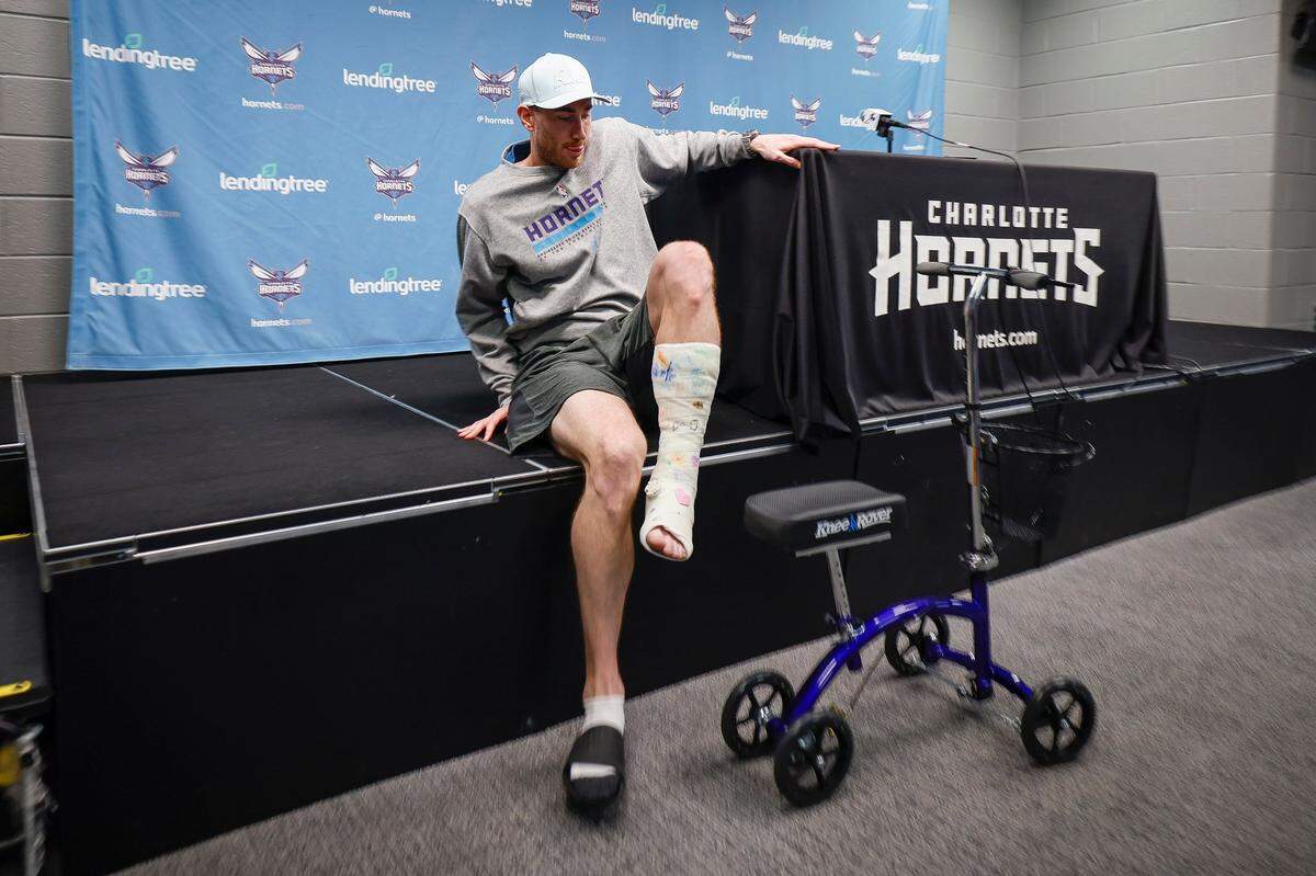 Charlotte Hornets forward Gordon Hayward (20) leaves the podium with his leg wrapped in a cast during season wrap up media conference at Spectrum Center in Charlotte, N.C., Thursday, April 14, 2022.