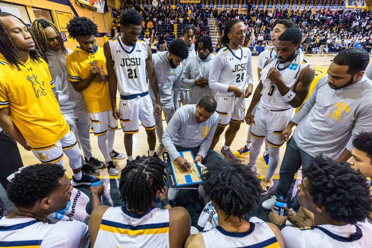 Johsnon C. Smith’s men’s basketball team surrounds interim head coach Antwain Banks during a timeout in Tuesday’s game against Livingstone.