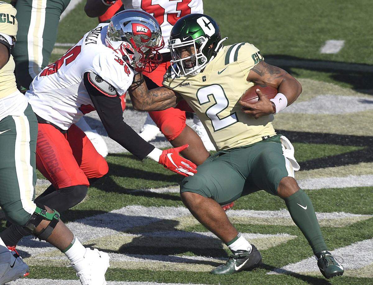 Charlotte 49ers quarterback Dom Shoffner, right, grimaces as he prepares to get tackled by WKU Hilltoppers linebacker Kyle Bailey, center, on Sunday, December 6, 2020.