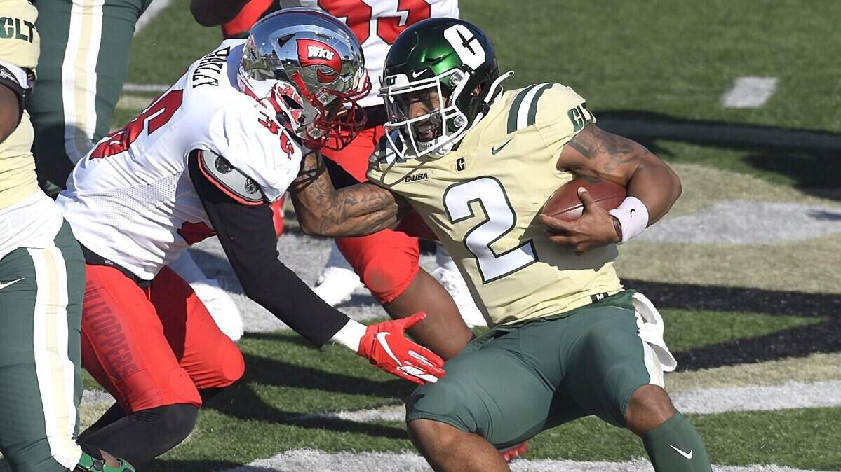 Charlotte 49ers quarterback Dom Shoffner, right, grimaces as he prepares to get tackled by WKU Hilltoppers linebacker Kyle Bailey, center, on Sunday, December 6, 2020.