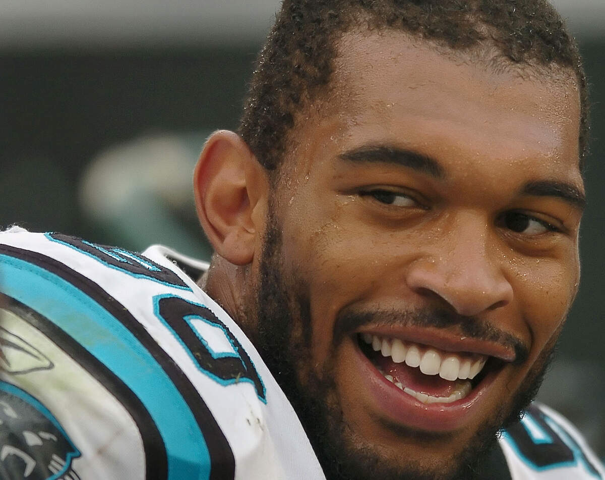 In 2006, Carolina Panthers defensive end Julius Peppers laughs on the team bench after chasing down Cleveland Browns quarterback Charlie Frye for a quarterback sack. Peppers had 159.5 sacks in his career, fourth all-time, and became a first-ballot Pro Football Hall of Famer in 2024.