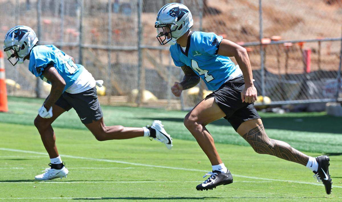 Carolina Panthers wide receiver Tetairoa McMillan, right, races across the field during the team’s rookie minicamp practice on Friday, May 9, 2025.