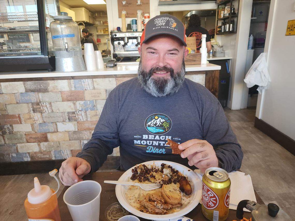 Insurance adjuster-turned-food review Tony Prieto at Cousins Cuban Cafe in Waynesville, wearing a Beach Mountain Diner shirt.
