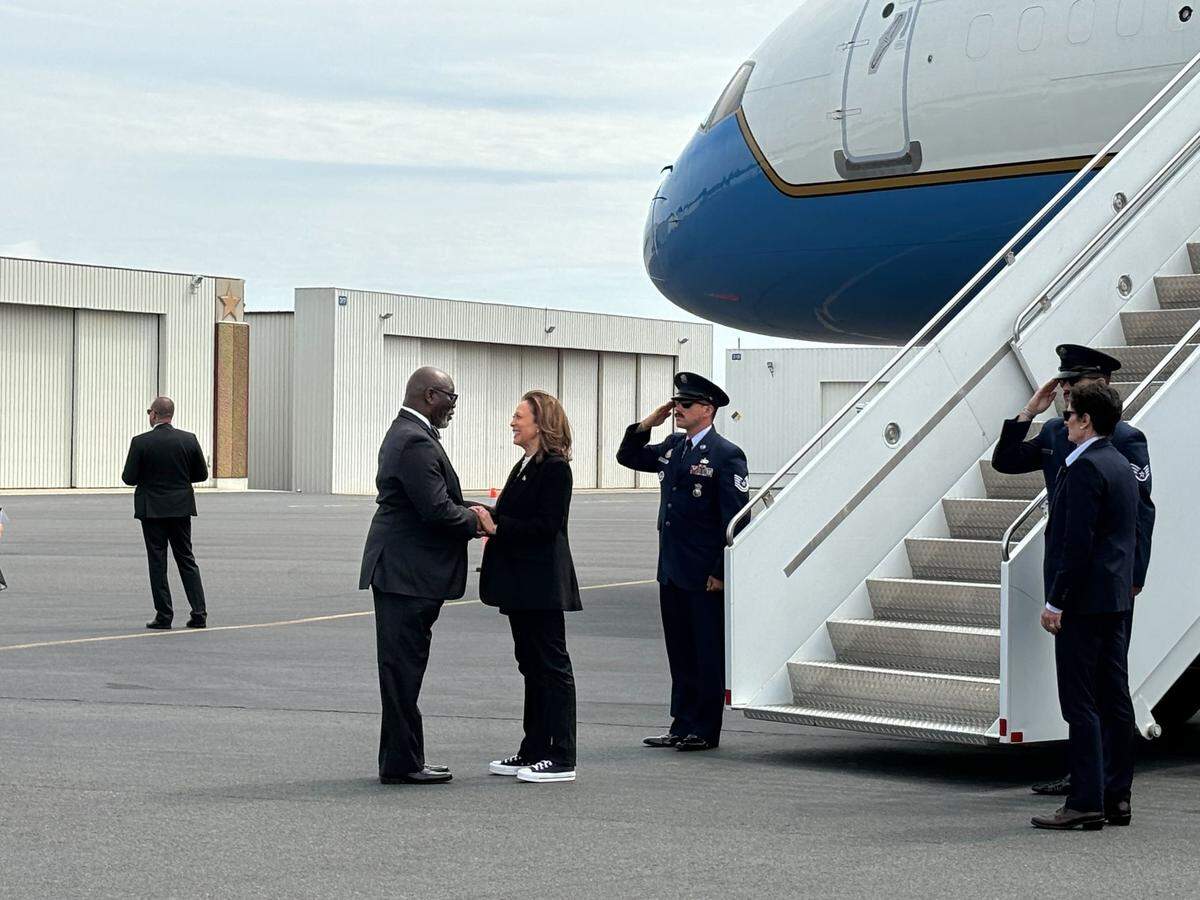 Vice President Kamala Harris is greeted at Charlotte Douglas international Airport by Mecklenburg County Board of Commissioners Chairman George Dunlap.