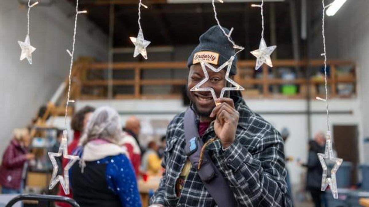 Kemoy Callaghan poses during the QC Family Tree Annual Epiphany Party at Enderly Coffee, Charlotte, December 2023.