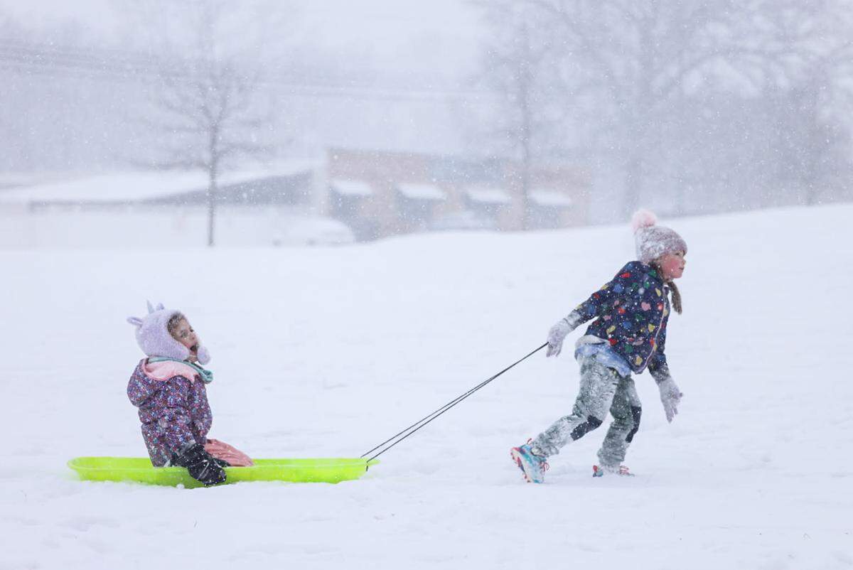 Kids have fun sledding at Cordelia Park in Charlotte as snow continues to fall on Saturday, Janaury 31.