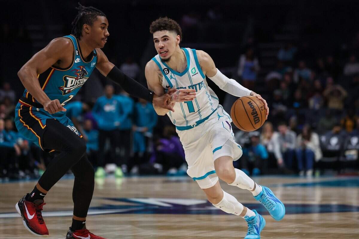 Hornets guard LaMelo Ball, right, drives the ball past Pistons guard Jaden Ivey during the game at Spectrum Center on Wednesday, December 14, 2022.