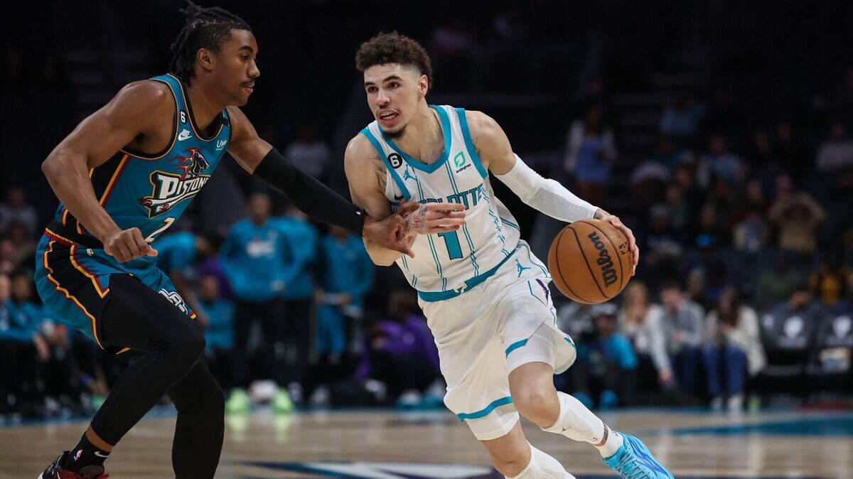 Hornets guard LaMelo Ball, right, drives the ball past Pistons guard Jaden Ivey during the game at Spectrum Center on Wednesday, December 14, 2022.