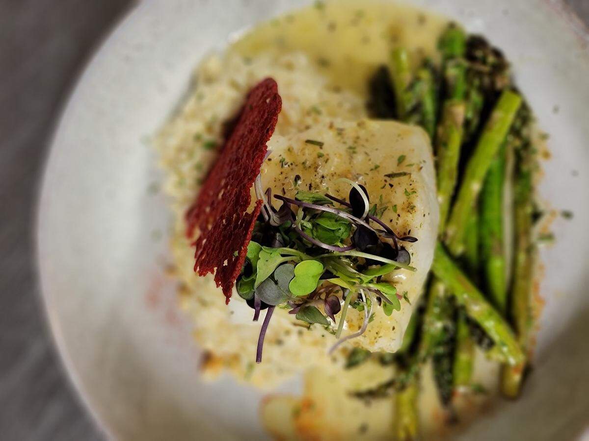 Roasted Sea Bass with parmesan rice, asparagus and a citrus beurre blanc.