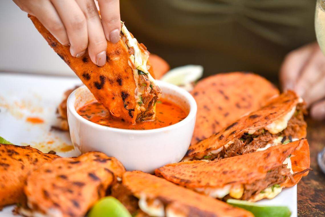 Traditional beef quesabirria is dipped in consommé.
