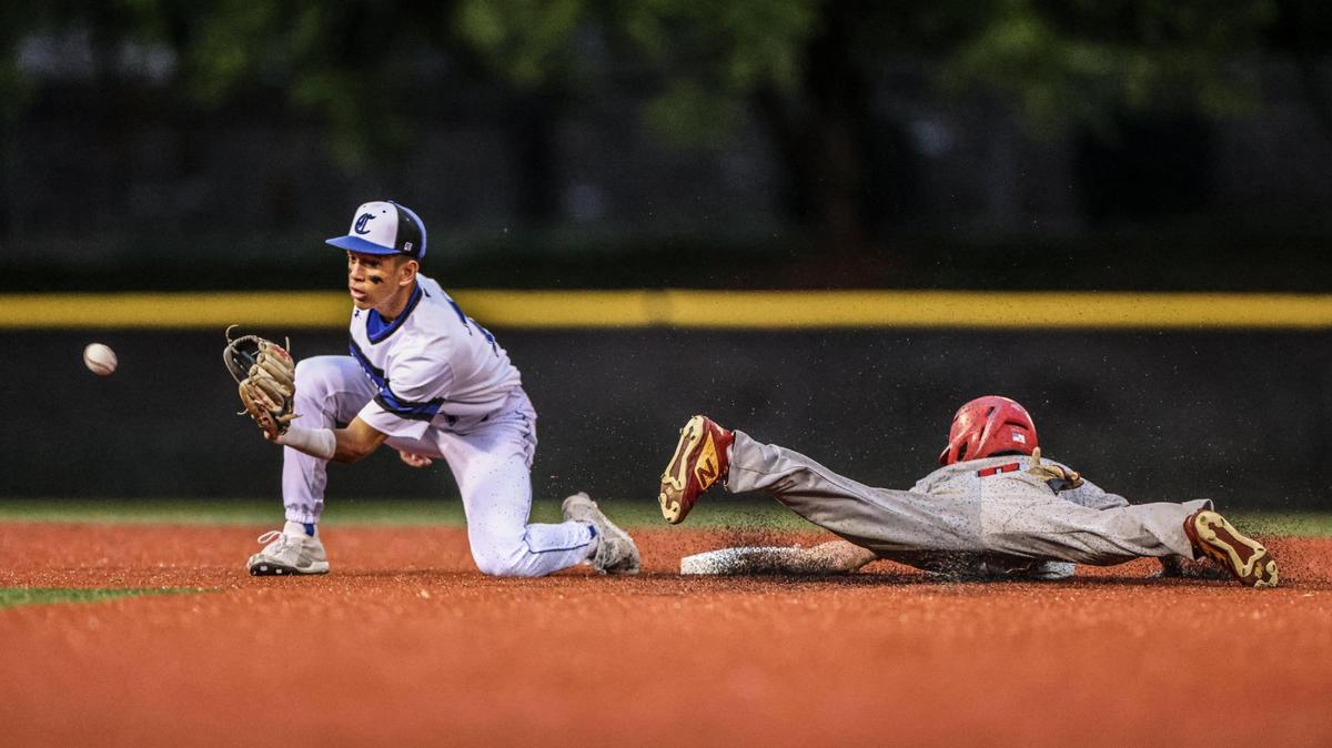Charlotte Christian’s Kevin Habluetzel, left, catches the ball as Providence Day’s Austin Ward slides safe into second at Charlotte Christian School in Charlotte, N.C., on Friday, April 8, 2022.