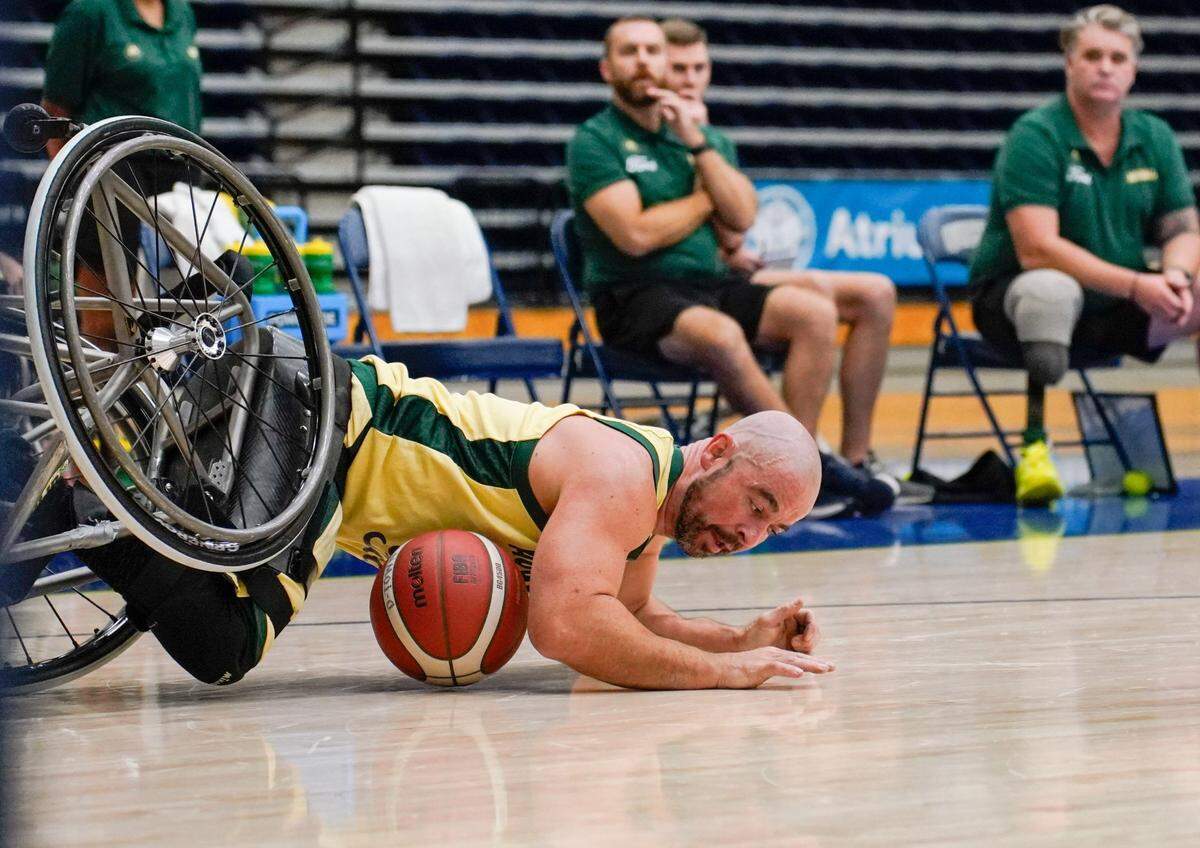 Tristan Knowles of team Australia falls onto the ground as he rolls into Brian Bell’s wheelchair from team USA during the Paralympic Wheelchair Basketball exhibition game on June 6, 2024, at Queens University basketball gym.