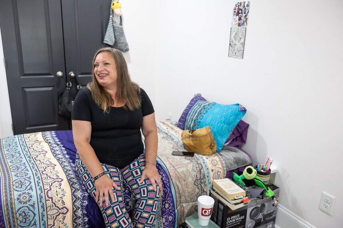 Karen Griffin sits in her room during the grand opening of A New Way of Life, a reentry home for formerly incarcerated women in Charlotte.