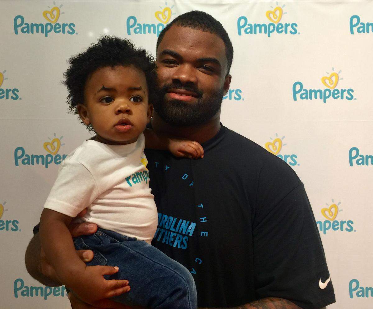 Carolina Panthers defensive tackle Dontari Poe poses with his 13-month-old son Jayden at a recent charity event at Discovery Place in Charlotte.