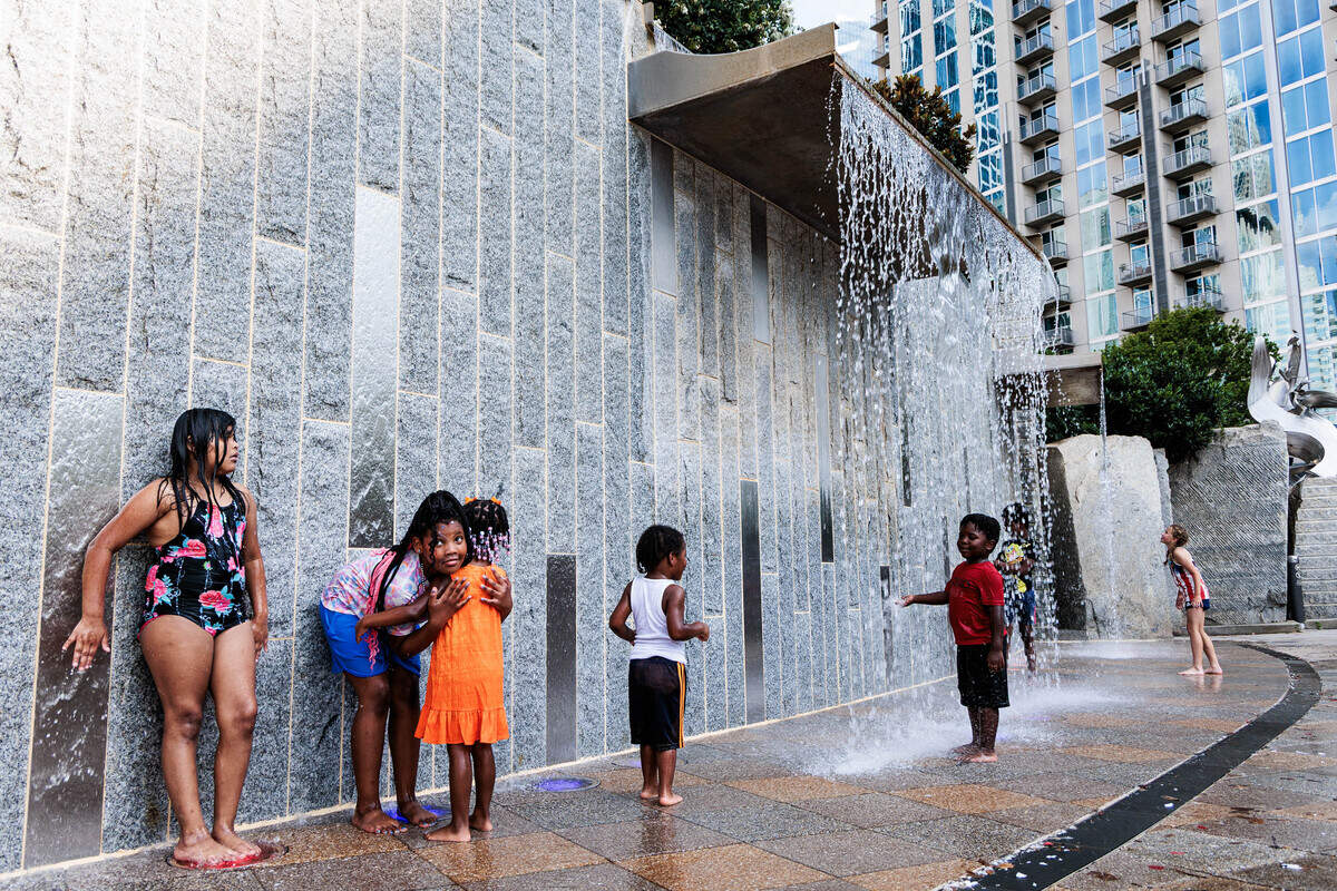 Children cool off from the record-breaking Independence Day heat on Saturday July 4, 2026 at Romare Bearden Park.