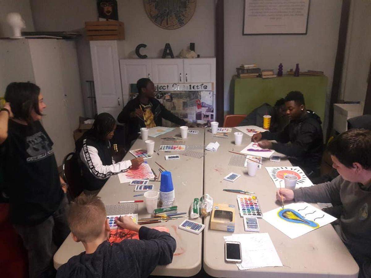 Students from TYM Inc. (Transforming Youth Movement) participate in a Guerilla Poets workshop at Charlotte Art League. Staff from Guerilla Poets led the group through an art workshop that focused on anger management.