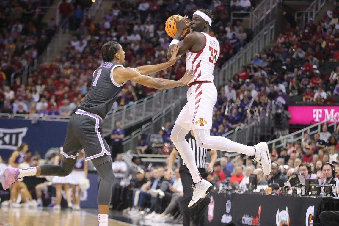 Iowa State freshman forward Omaha Biliew (33) catches a pass as Kansas State senior forward David N’Guessan (1) defends in the quarterfinal round in the Big 12 Tournament inside the T-Mobile Center in Kansas City, Mo. in March 2024.