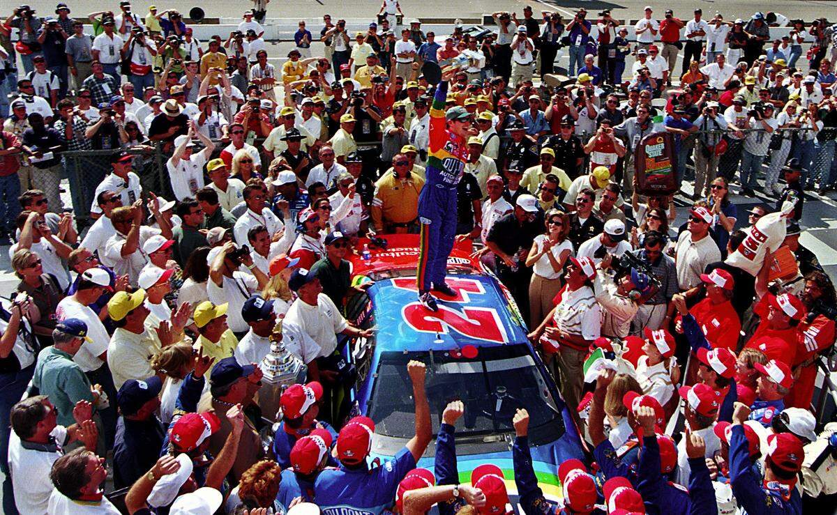 Gordon (center) celebrates in Victory Lane after winning the 1998 Brickyard 400 Race at Indianapolis Motor Speedway.