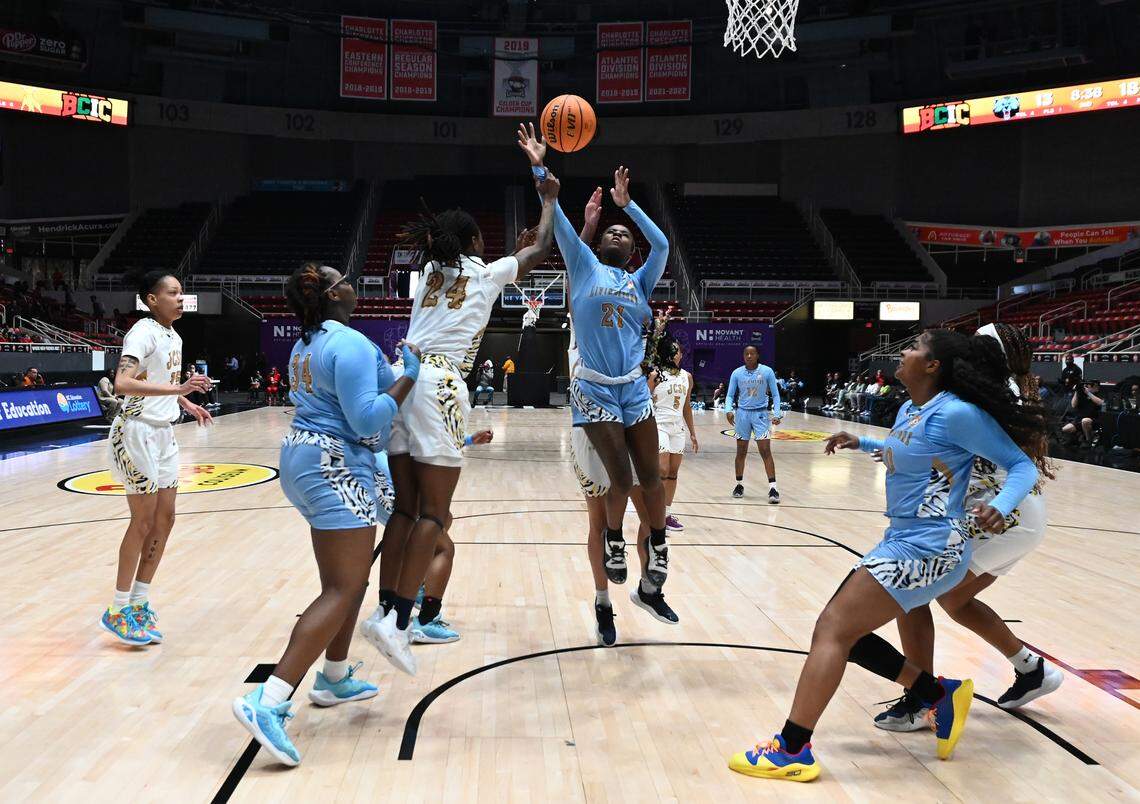 Livingstone College’s Thalia Carter, center, battles for control of the ball against the Johnson C. Smith University defense during action at Bojangles Coliseum in Charlotte, NC on Thursday, March 20, 2025. Livingstone College faced JCSU during first day action of the Black College Invitational Championship (BCIC).