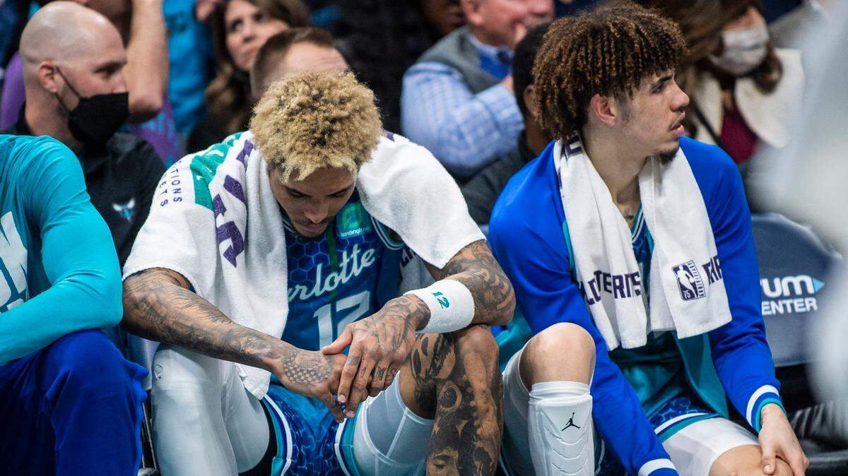 Charlotte Hornets guard Kelly Oubre, Jr., left, hangs his head on the bench during a game against the Grizzlies at Spectrum Center last month. Oubre is in a shooting slump.