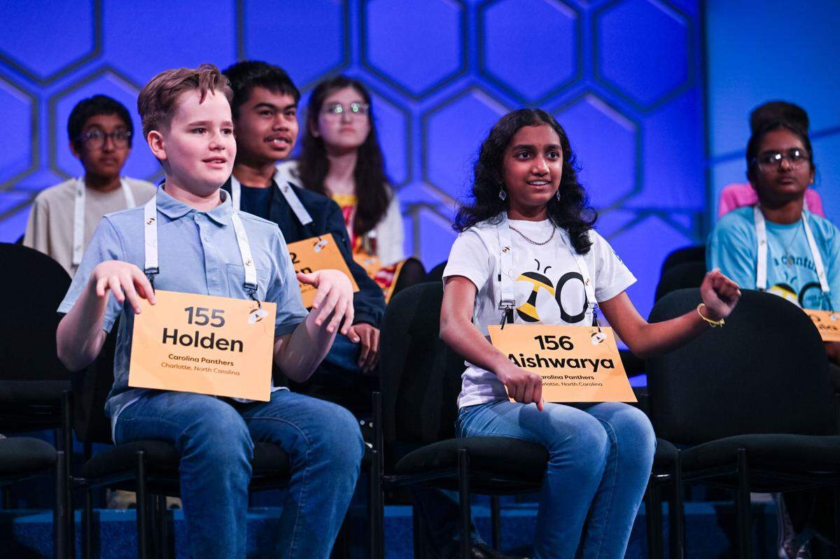 Holden Good, left, sits alongside Aishwarya Kallakuri, right, onstage at the 2025 Scripps National Spelling Bee in National Harbor, Maryland. They were the last two remaining NC spellers in the competition until Good’s elimination in the ninth round.