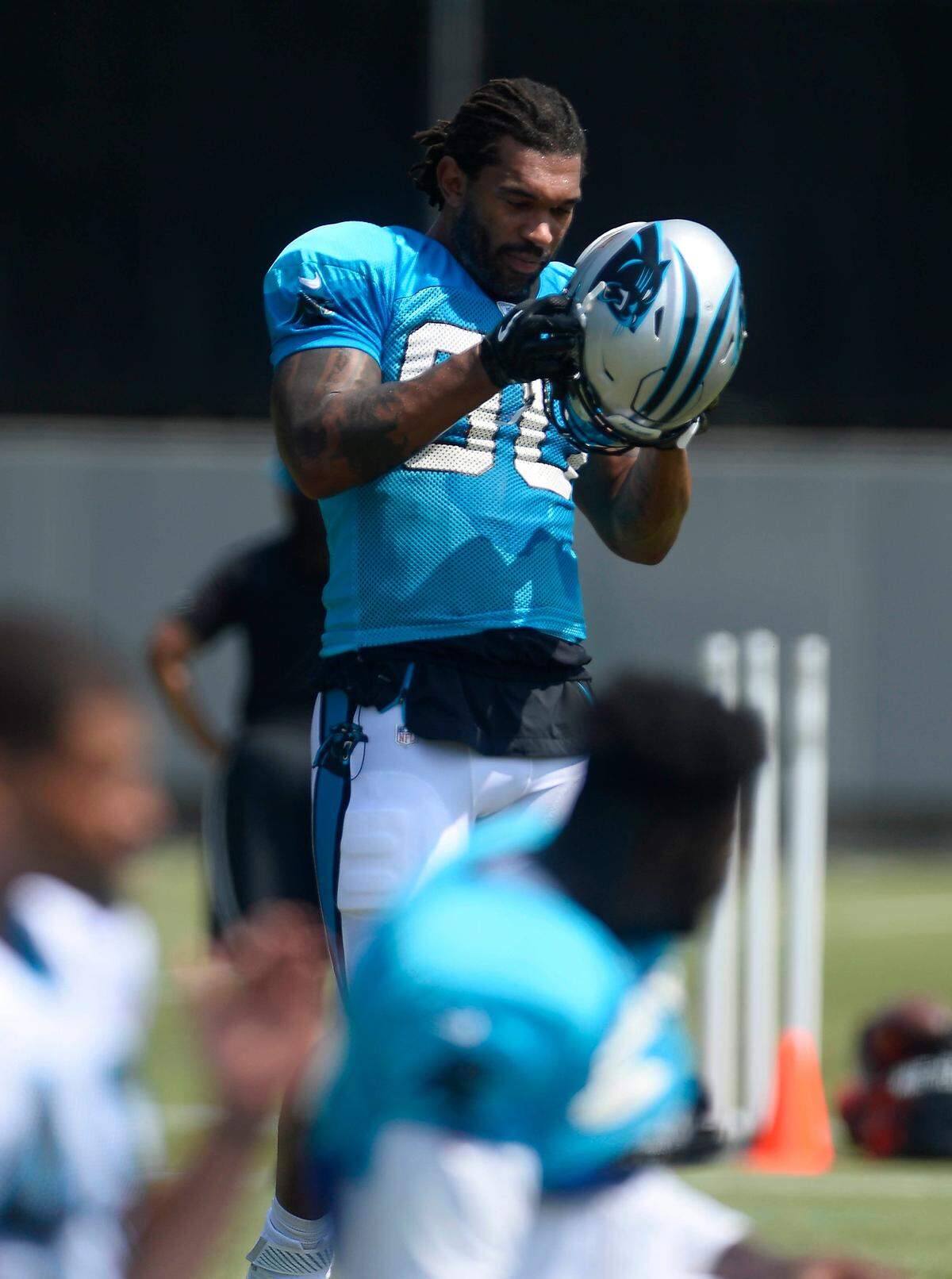 Carolina Panthers defensive end Julius Peppers (90) provided a jolt at practice on Monday by participating fully, but another offensive linemen has been slowed by injury.