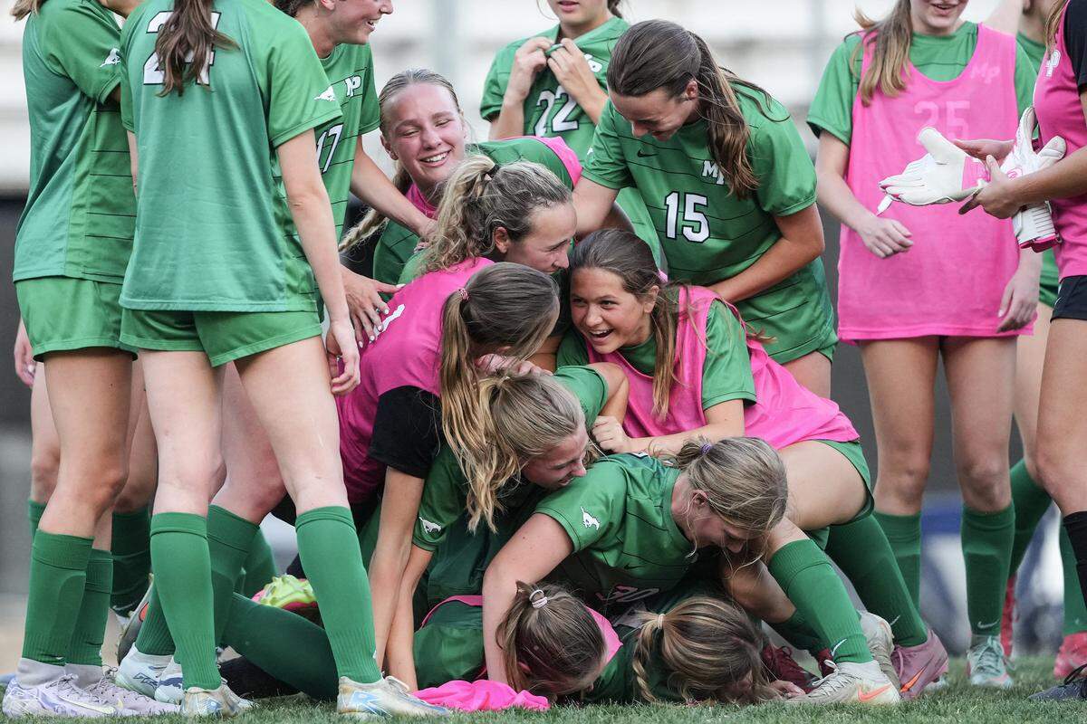 Myers Park celebrates after defeating Northwest Guilford in a NCHSAA girls playoff soccer match, Monday, May 18, 2026, in Charlotte, N.C. 