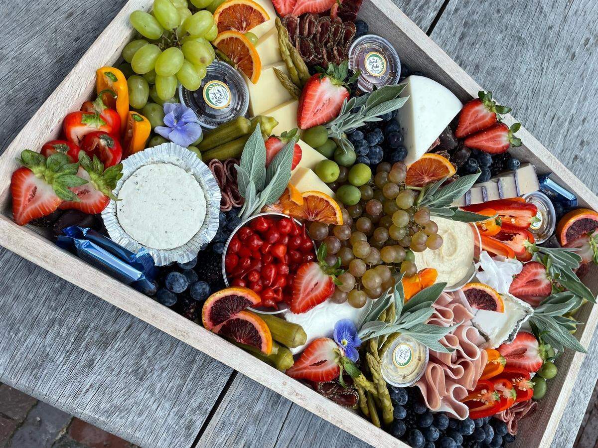 The Board Babe is a café specializing in artisan charcuterie boards and upscale catering at Optimist Park in Charlotte.