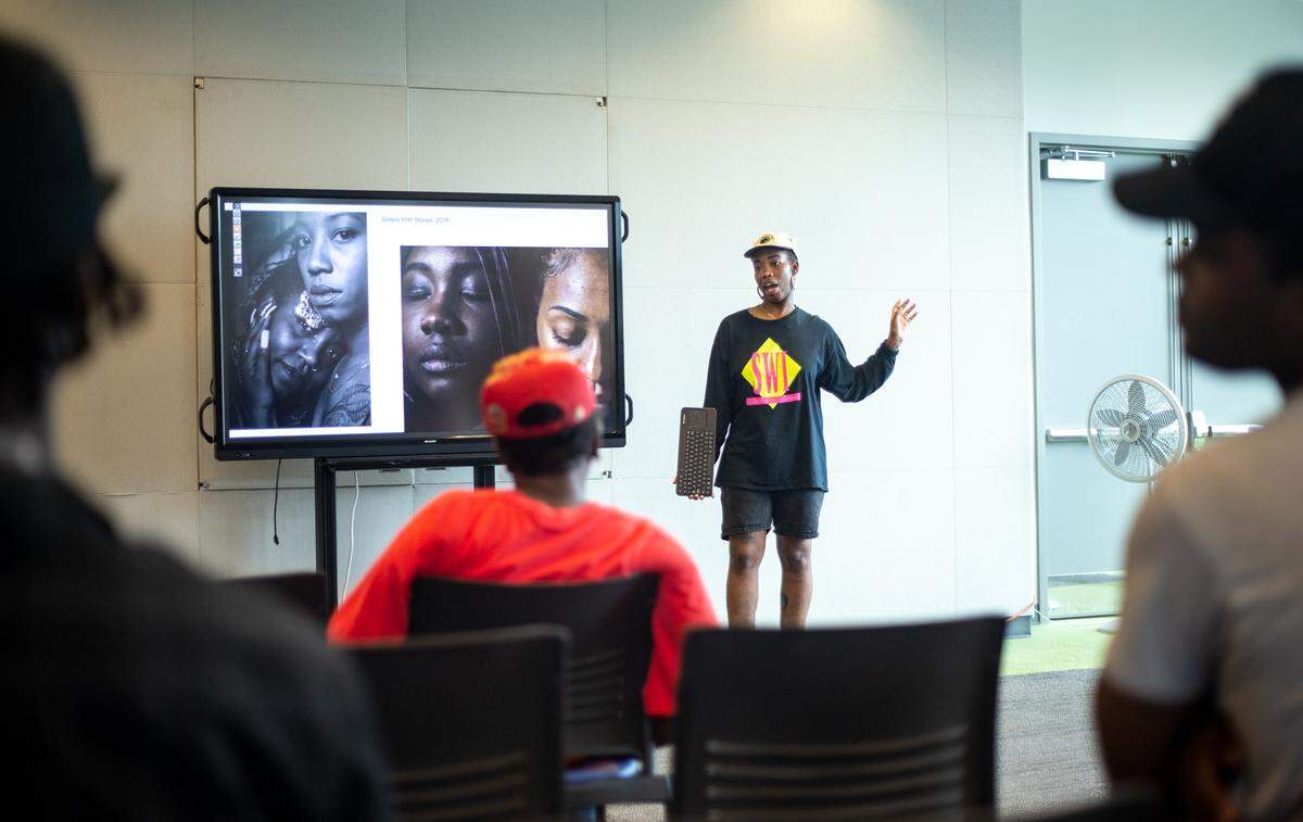 Shan Wallace of Baltimore is the current artist-in-residence at The Roll Up CLT. Here, she’s speaking to a group at the Beatties Ford library branch about one of her latest projects: “Sisters with Stories.” She’ll be working on it while in Charlotte. Her goal is to create a visual archive of the social, cultural and political narratives of black life.