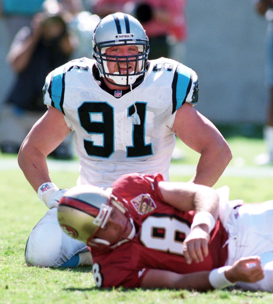 Kevin Greene smiles over fallen San Francisco quarterback Steve Young in 1996. Greene led the NFL in sacks that season with 14.5, at age 34.