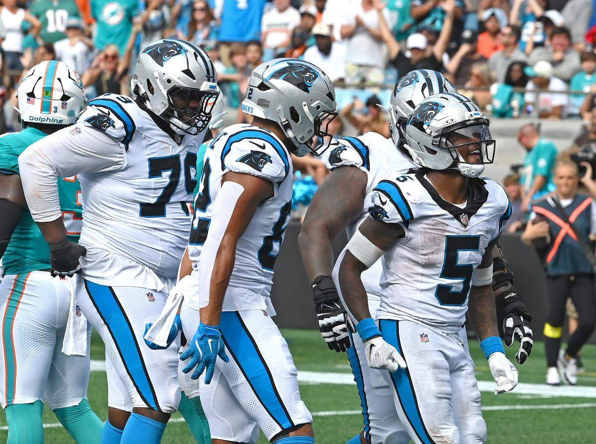 Carolina Panthers running back Rico Dowdle, right, celebrates his rushing touchdown during fourth quarter action against the Miami Dolphins on Sunday, October 5, 2025, at Bank of America Stadium in Charlotte, NC. The Panthers defeated the Dolphins 27-24.