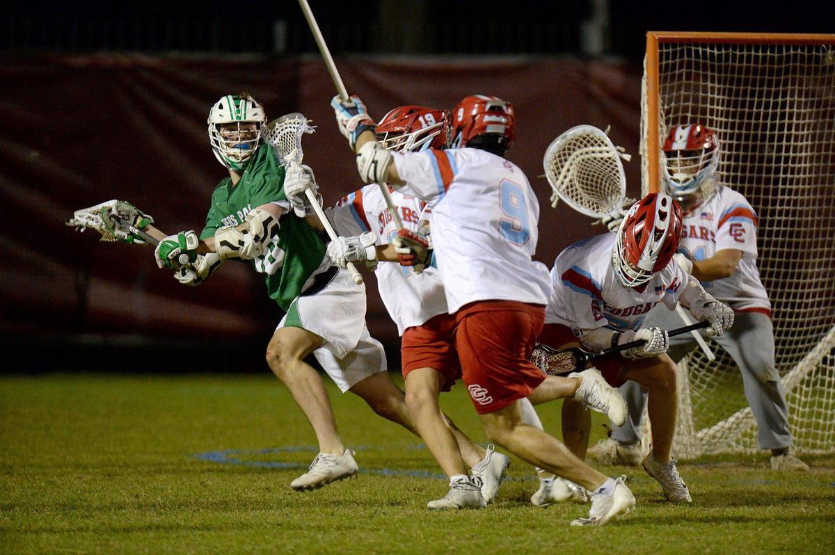 Myers Park’s, #20, James White, is harassed by the Charlotte Catholic defense. Charlotte Catholic, ranked #1 in North Carolina and #3 nationally put a perfect, 13-0 record, on the line against 6-3 Myers Park for a match of boys lacrosse teams. The teams were tied 9-9 after the first half. Catholic’s Jack Ransom, a Georgetown recruit, is a standout player. The teams battled on Monday, April 8, 2024.