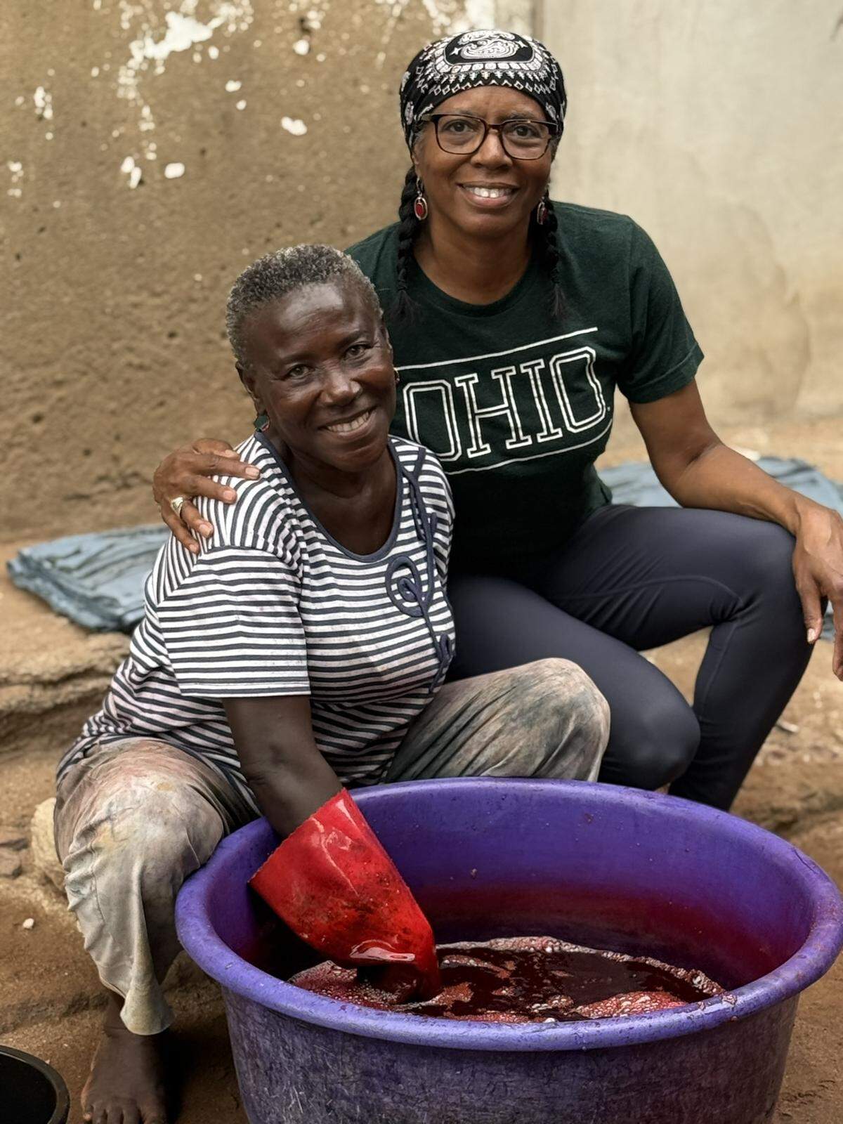 Charlotte artist Lydia Thompson, right, with batik artist “Auntie Matta,” with whom she studied batik art and tye die techniques during her trip to Ghana.
