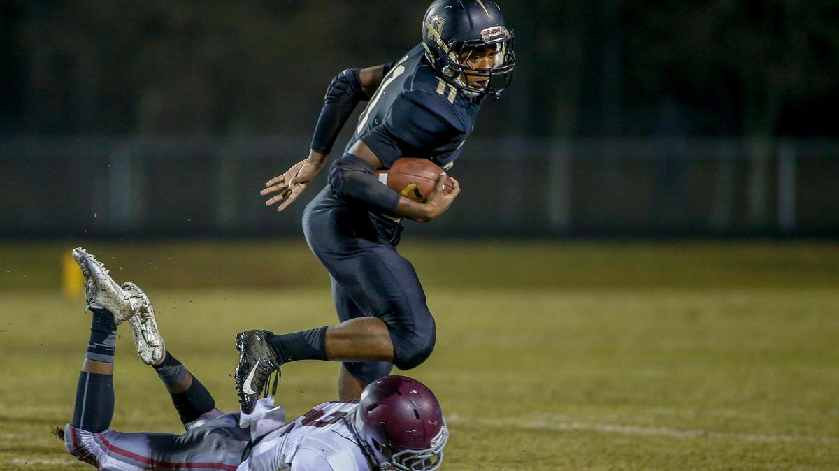 Providence running back Jamar Price (11) avoids West Mecklenburg cornerback Kynieu Wylie in the first quarter of the Panthers 48-8 win Friday