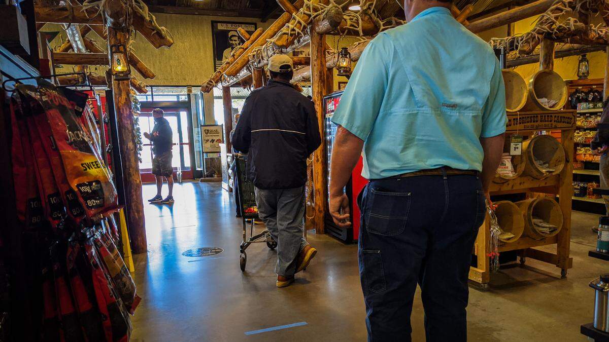 People socially distance while standing in line at the Bass Pro Shop at Concord Mills, May 12, 2020. 