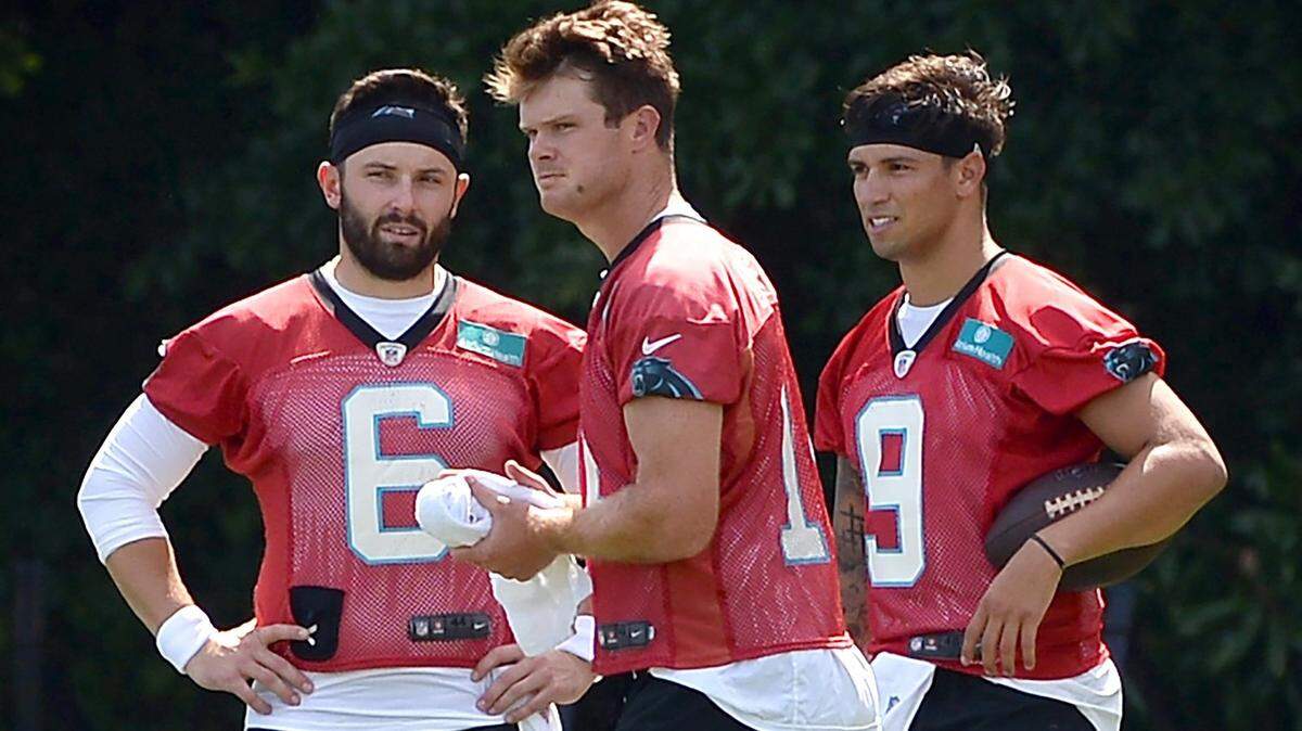 Carolina Panthers quarterbacks Baker Mayfield, left, Sam Darnold, center and Matt Corral, right, wait along a sideline to resume drills on Wednesday, July 27, 2022 at Wofford College in Spartanburg, SC.