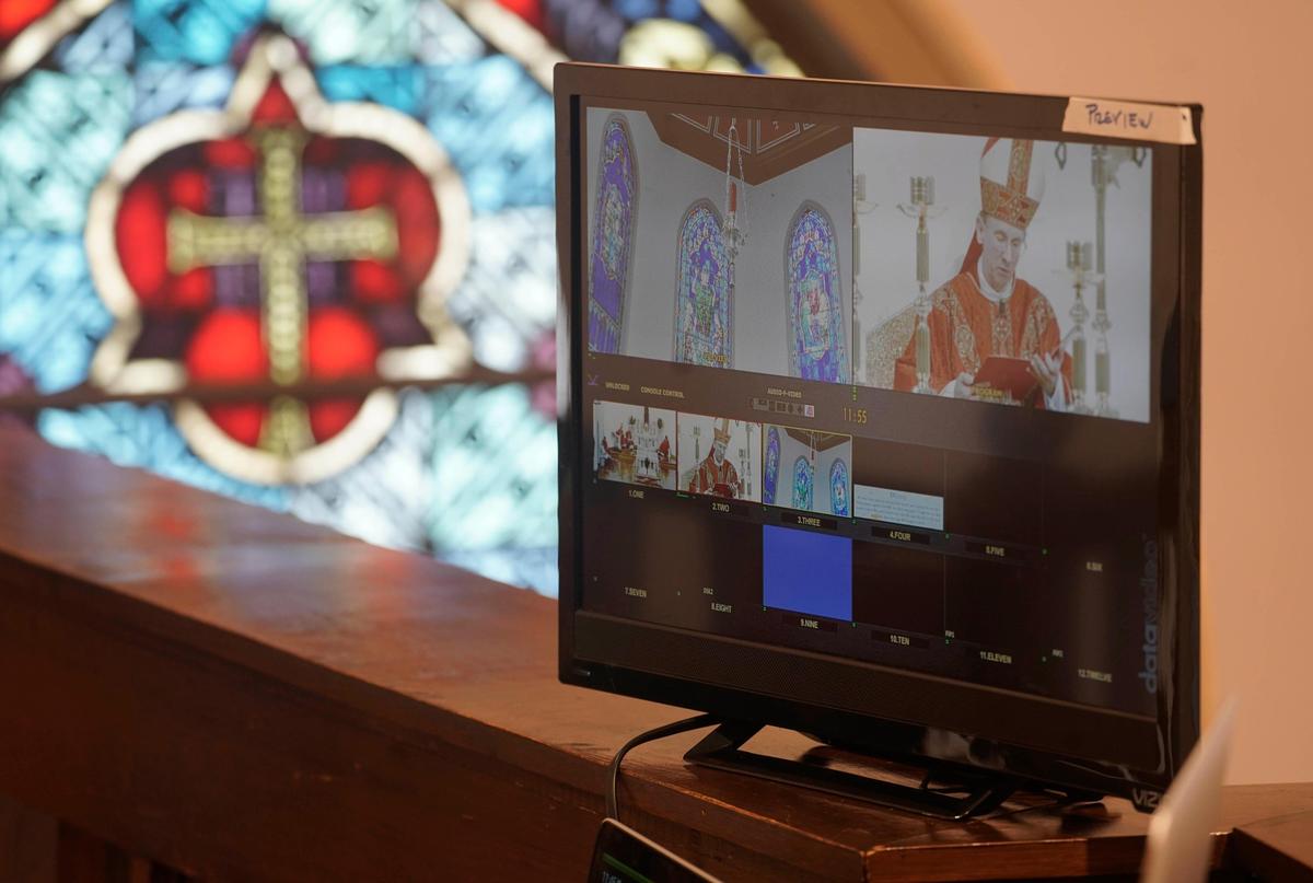 A video feed of Palm Sunday services displayed on a monitor inside the empty St. Patrick Cathedral in Charlotte on Sunday, April 5, 2020. 