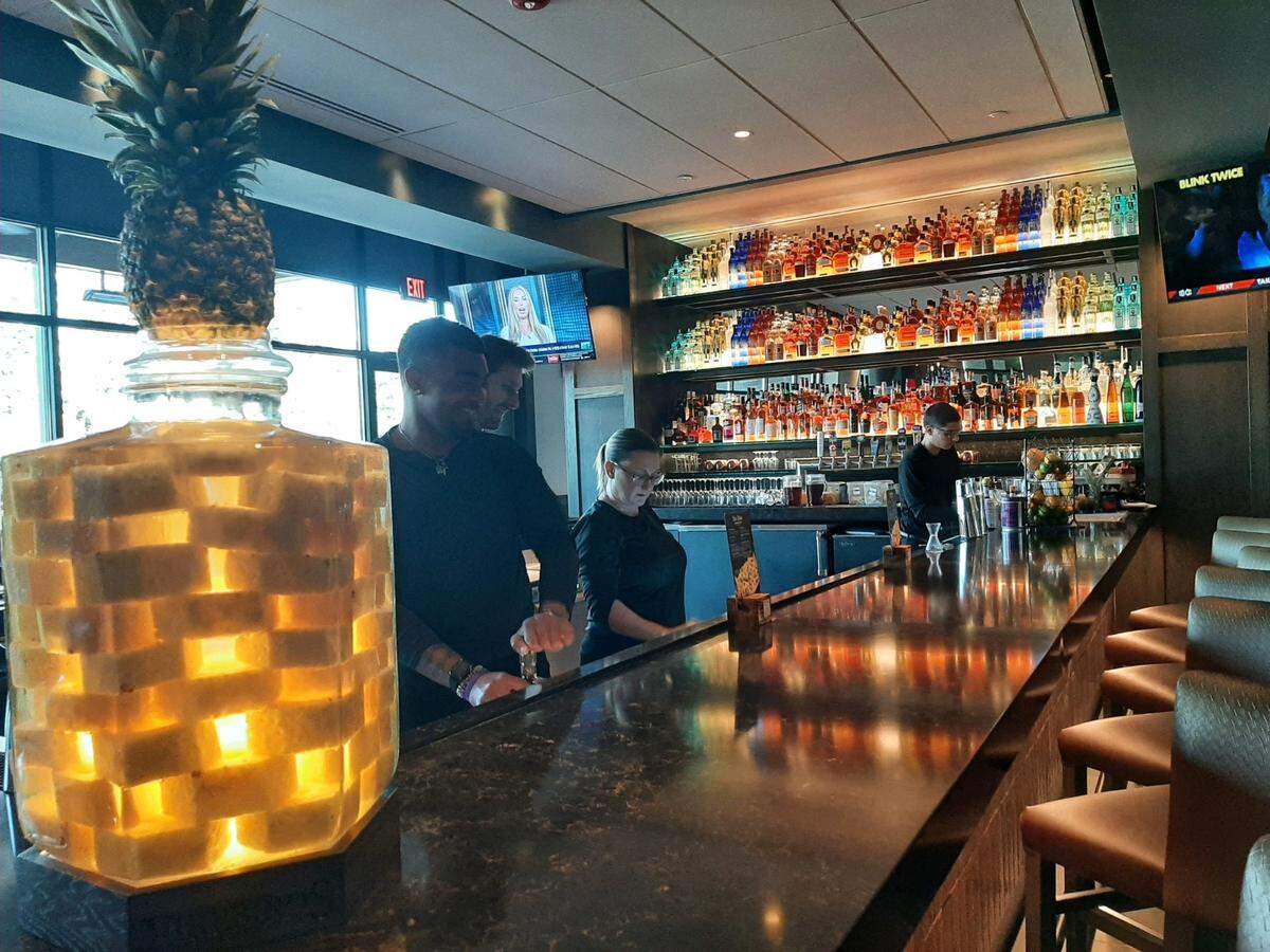 Staff at Firebirds Wood Fired Grill serve drinks in preparation for Monday’s opening in Fort Mill.