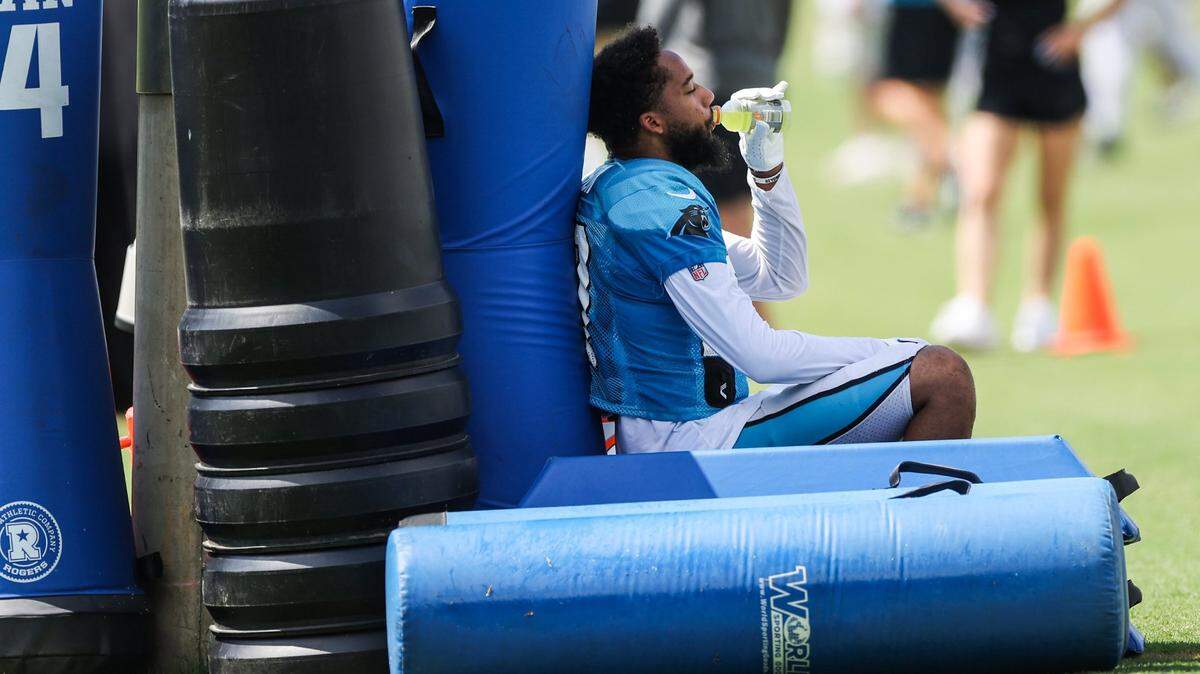 Panthers safety Kenny Robinson hydrates during a break between practices at training camp on Tuesday, August 9, 2022 in Spartanburg, SC.