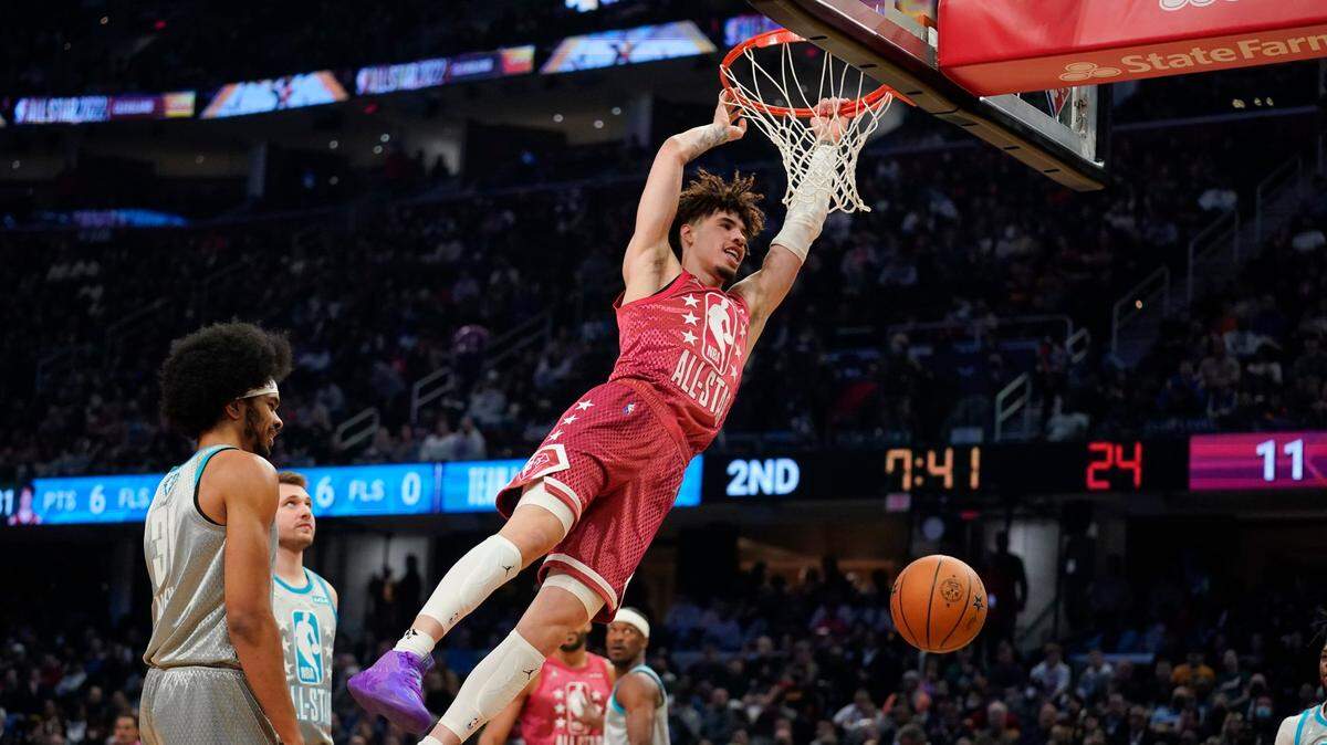 Charlotte Hornets’ LaMelo Ball finishes off a dunk in front of Cleveland Cavaliers’ Jarrett Allen (31) during the first half of the NBA All-Star basketball game, Sunday, Feb. 20, 2022, in Cleveland. (AP Photo/Charles Krupa)